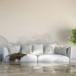 Living room in a home filled with water that reaches the seat of a white couch