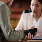 Person with injured hand sitting across from a lawyer